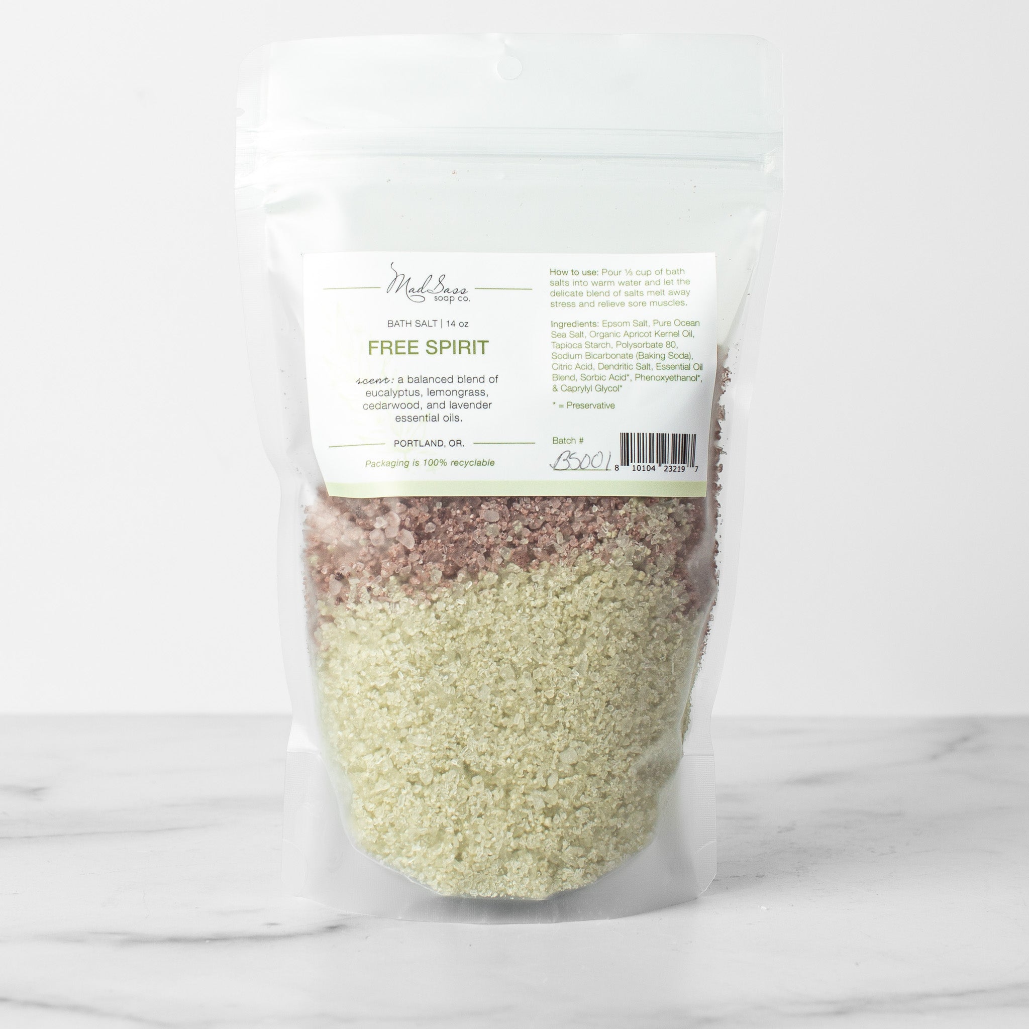 One bag of Free Spirit bath salts on a white background. Free Spirit is a two toned layered bath salt in green and purple.