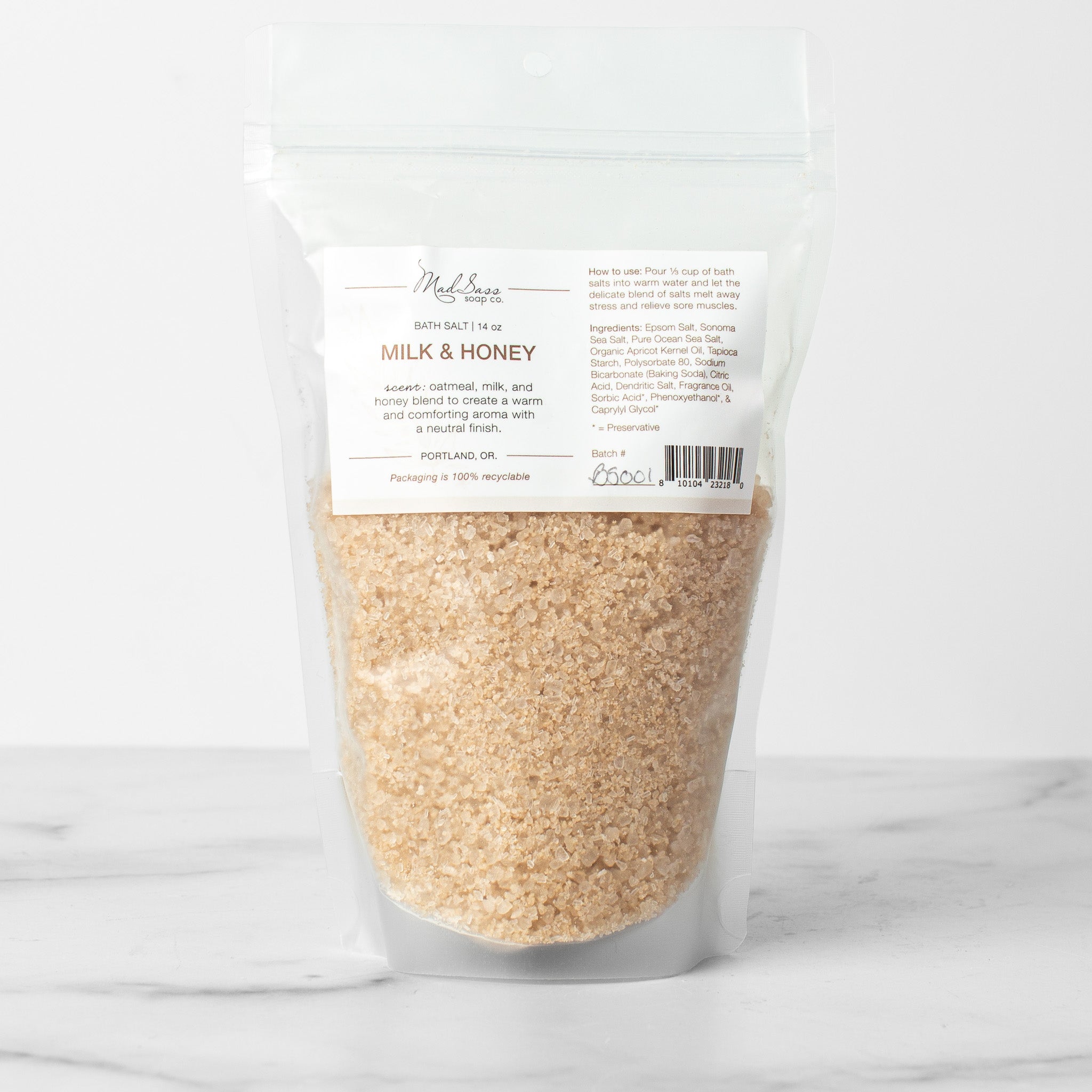 One bag of Milk & Honey bath salts on a white background. Milk & Honey is a soft oatmeal tan bath salt.