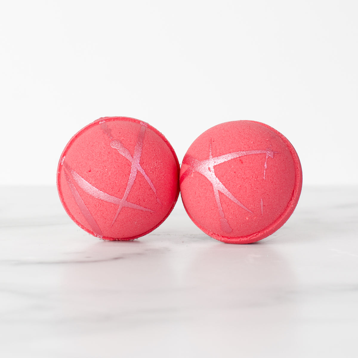 Citrus Blossom hydrating luxury bath bomb by Mad Sass Soap Co, featuring two vibrant pink bath bombs with shimmering accents, perfect for a relaxing spa experience.