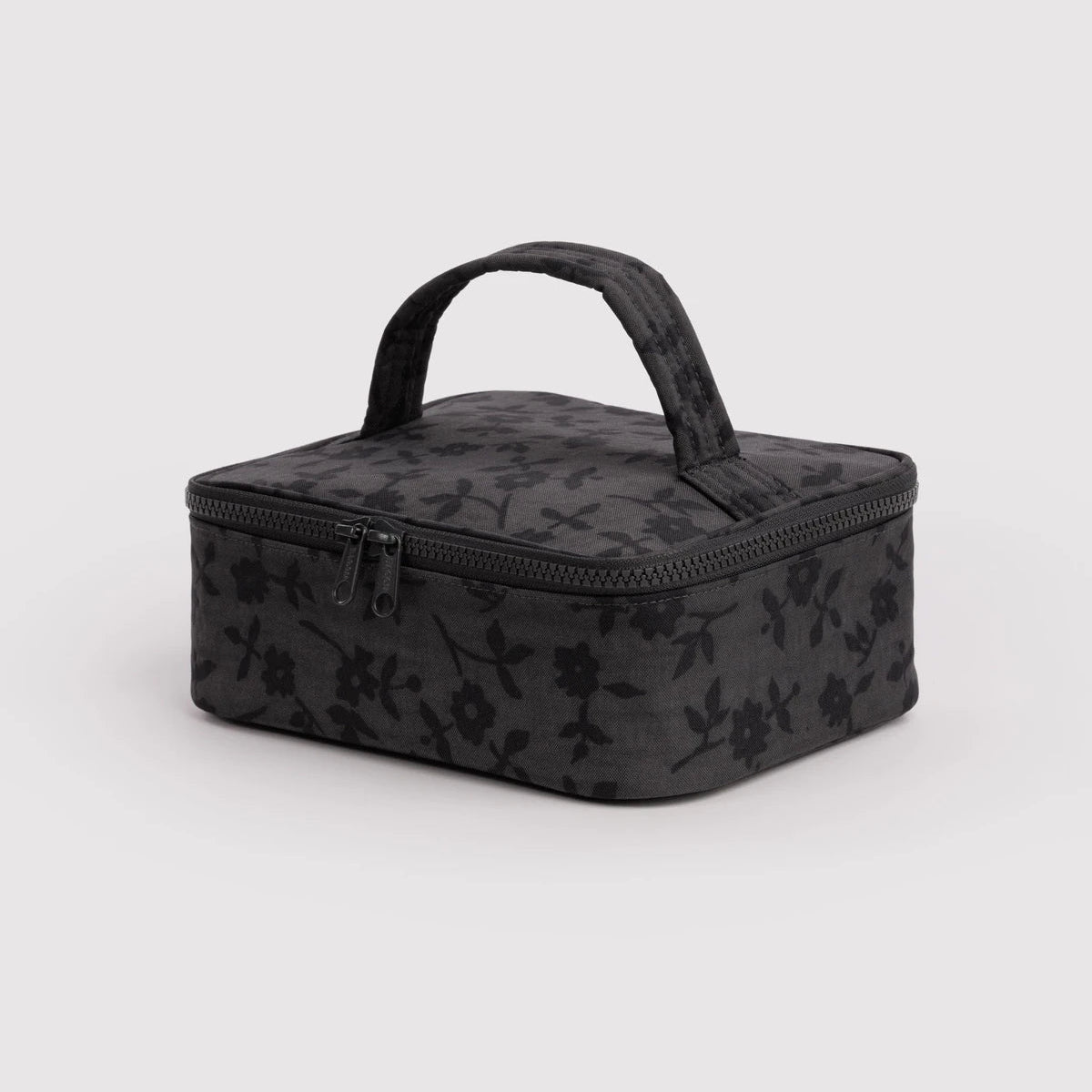 Black floral-patterned travel case on a light gray background