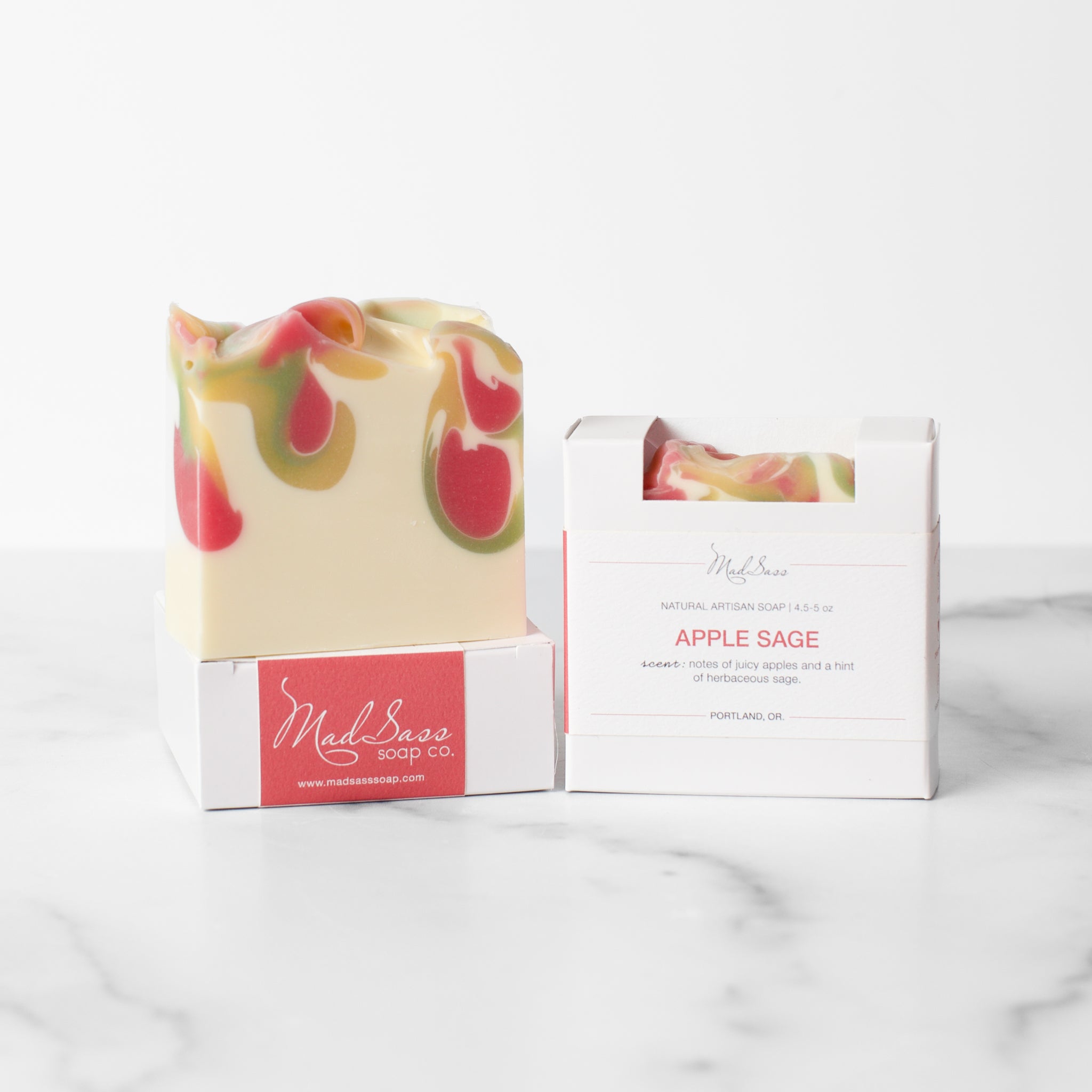 Luxurious Apple Sage artisan handcrafted soap by Mad Sass Soap Co, featuring a beautifully swirled design with vibrant colors, presented in elegant packaging.