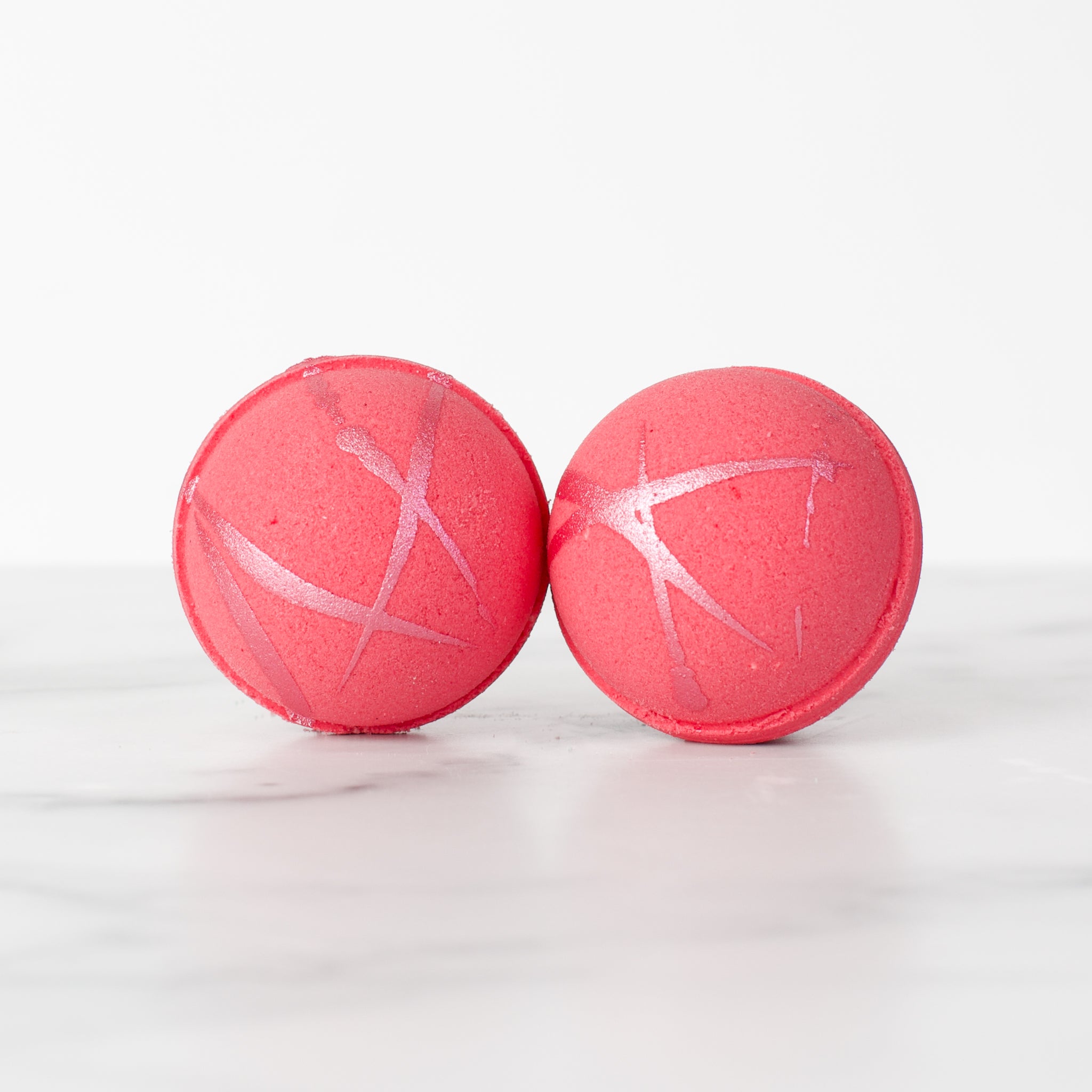 Citrus Blossom hydrating luxury bath bomb by Mad Sass Soap Co, featuring two vibrant pink bath bombs with shimmering accents, perfect for a relaxing spa experience.