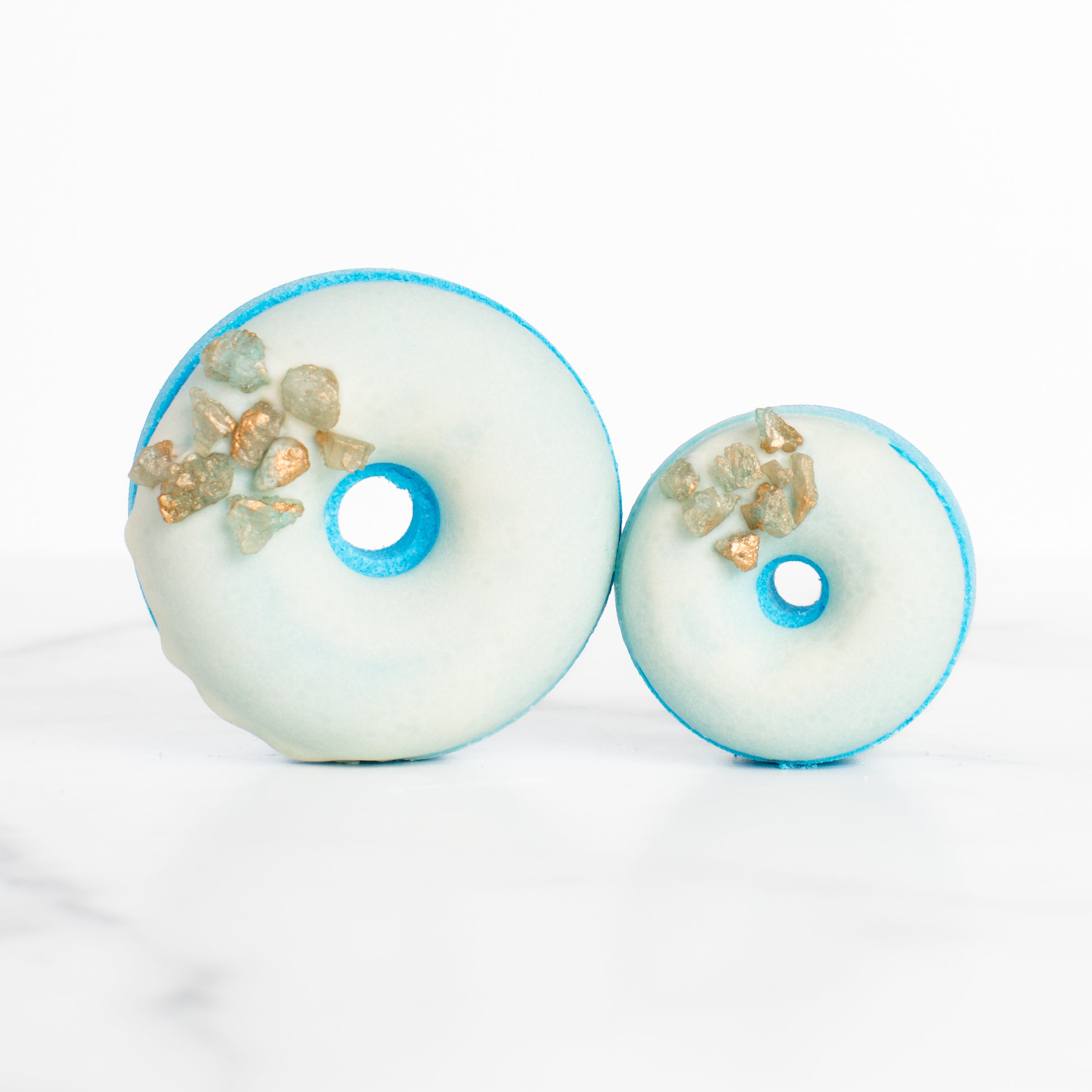 Luxury Sea Salt & Neroli bath bomb by Mad Sass Soap Co, showcasing a donut-shaped design with precious gemstones, embodying a hydrating luxury bath bomb experience.
