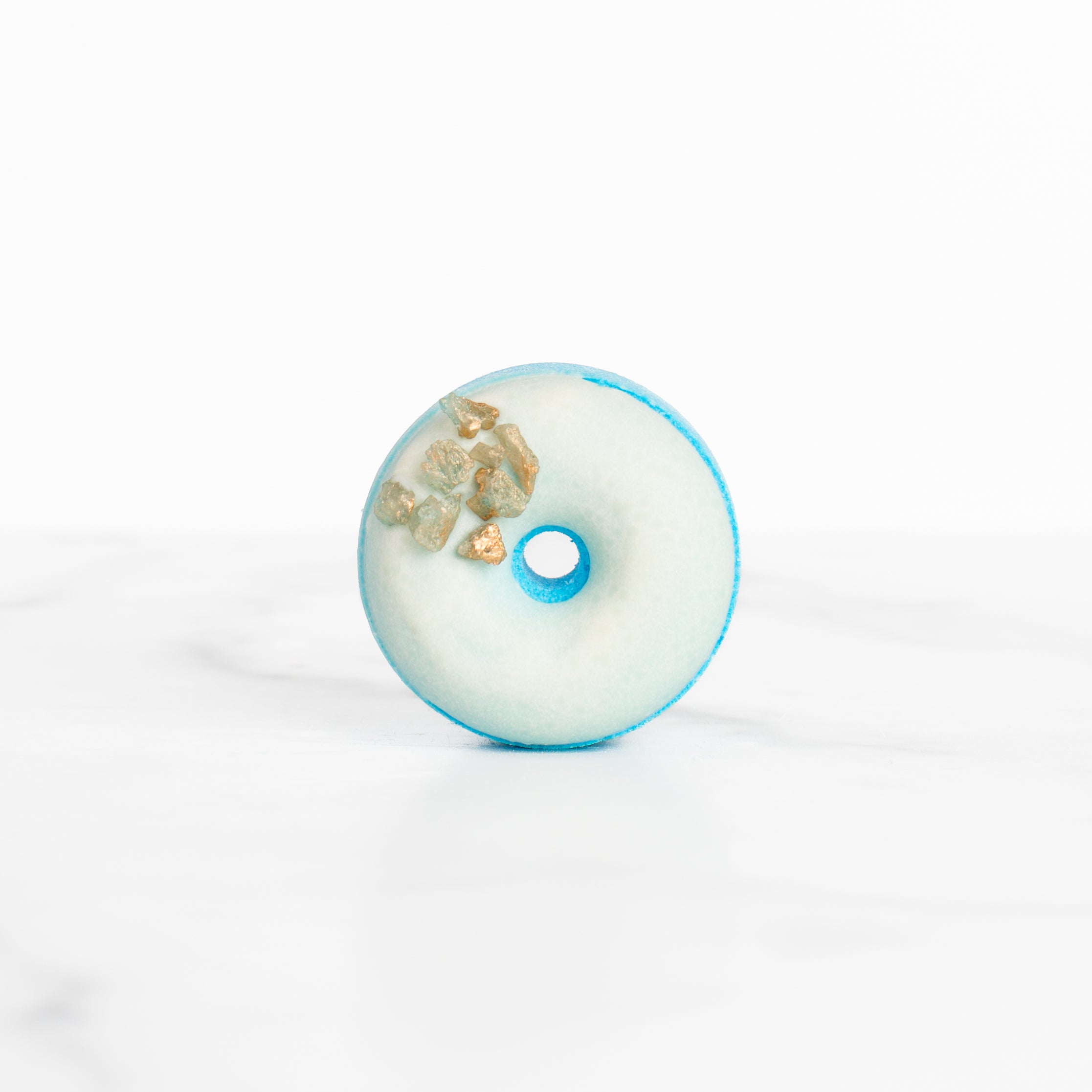 Close-up of the luxurious Sea Salt & Neroli bath bomb by Mad Sass Soap Co, featuring a stunning donut shape adorned with gemstones, ideal for a hydrating luxury bath bomb experience.