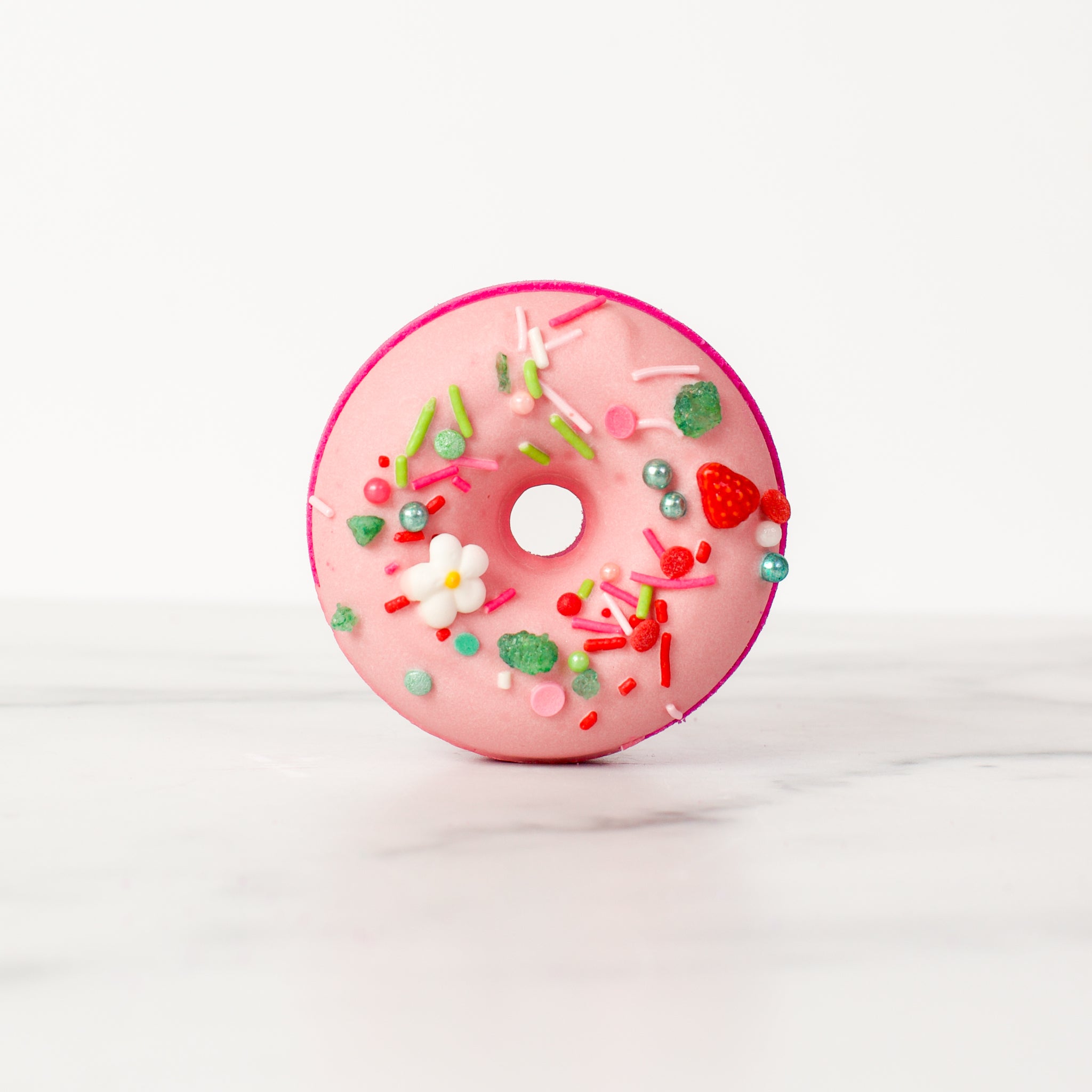 Elegant Sonoma Strawberry - Bath Bomb by Mad Sass Soap Co, displaying a charming donut shape in pink, complete with playful sprinkles, representing a true hydrating luxury bath bomb.