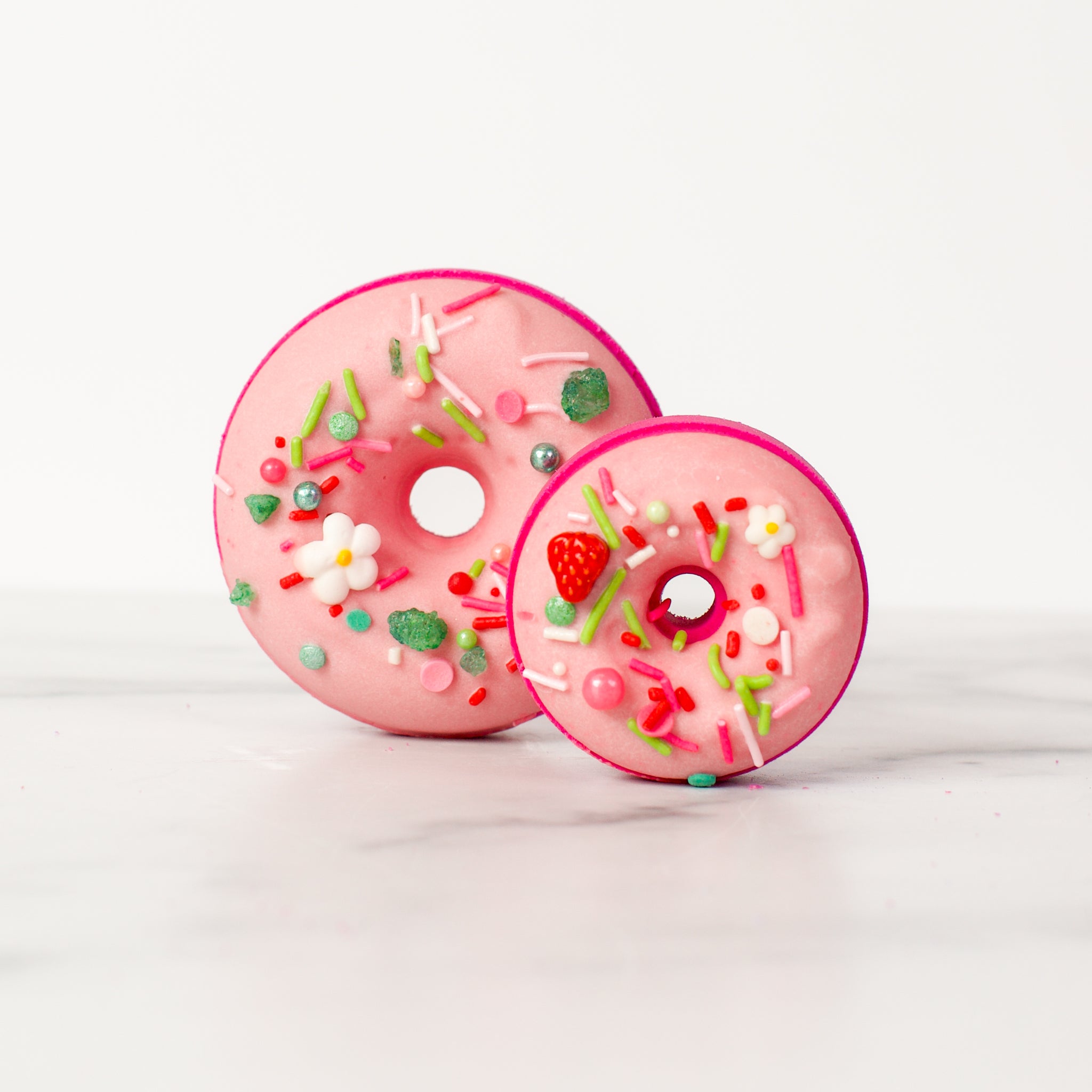 Exquisite Sonoma Strawberry - Bath Bomb by Mad Sass Soap Co, showcasing the delightful pink donut design adorned with vibrant sprinkles, perfect for a hydrating luxury bath experience.