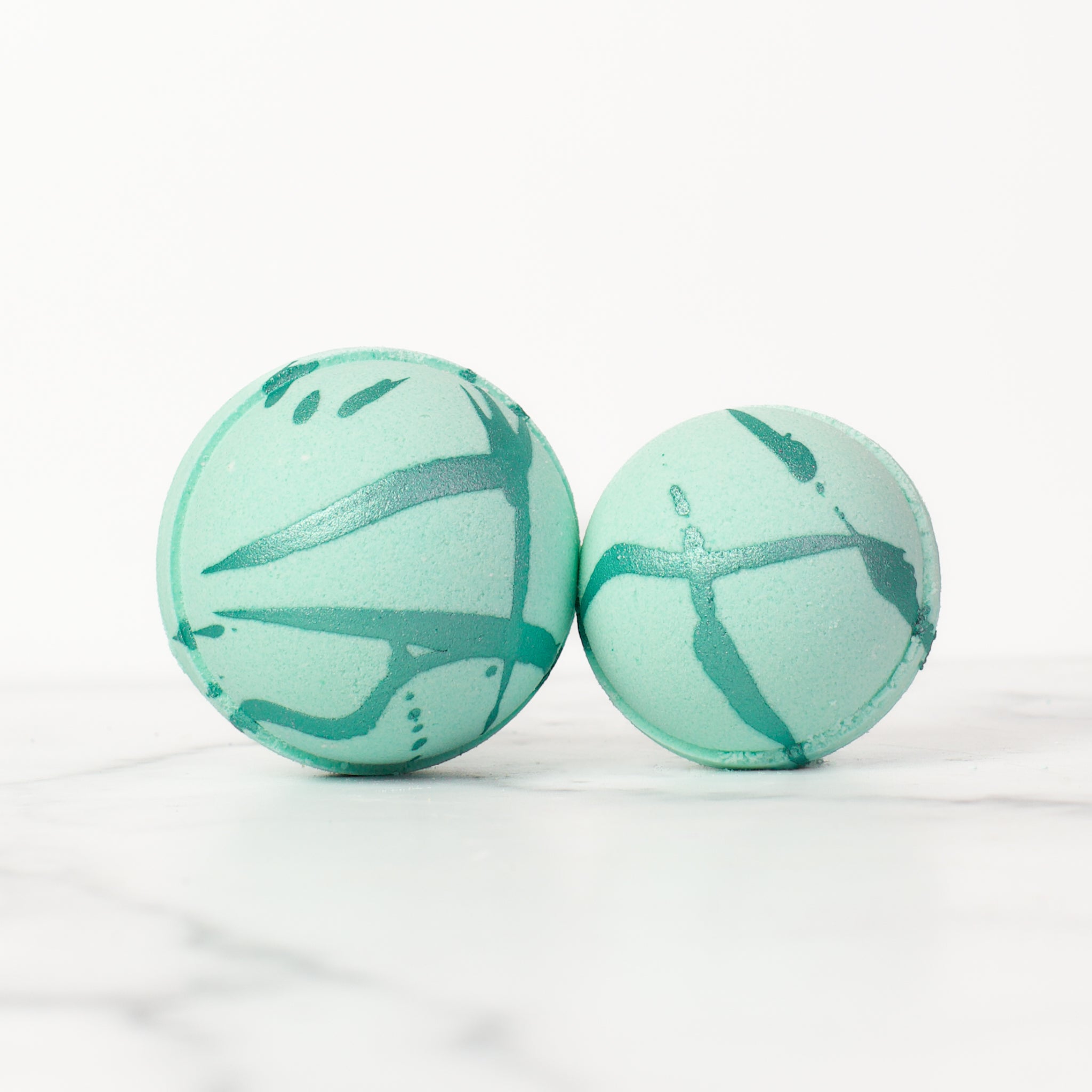 Luxurious Spa Day bath bomb from Mad Sass Soap Co, featuring a beautiful teal design with artistic splashes, perfect for a relaxing bath experience.