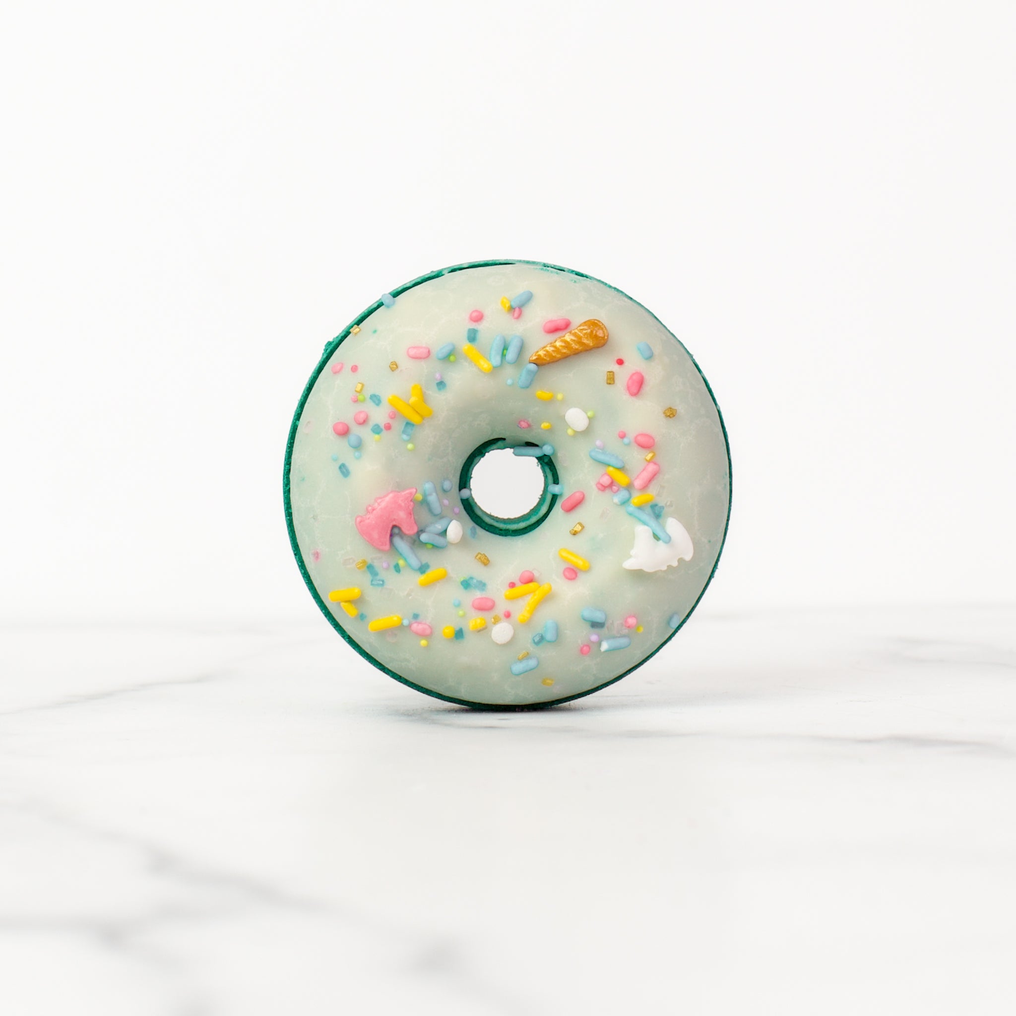 Elegant Volcano Bath Bomb by Mad Sass Soap Co, showcasing a beautifully decorated donut shape with vibrant sprinkles, designed for a hydrating luxury bath ambiance.