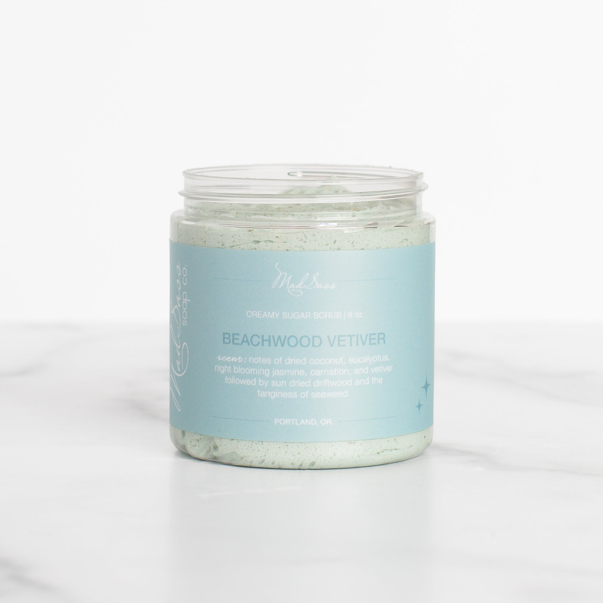 Close-up of Beachwood Vetiver hydrating luxury sugar scrub from Mad Sass Soap Co, highlighting the smooth and creamy consistency in an aesthetically pleasing container.