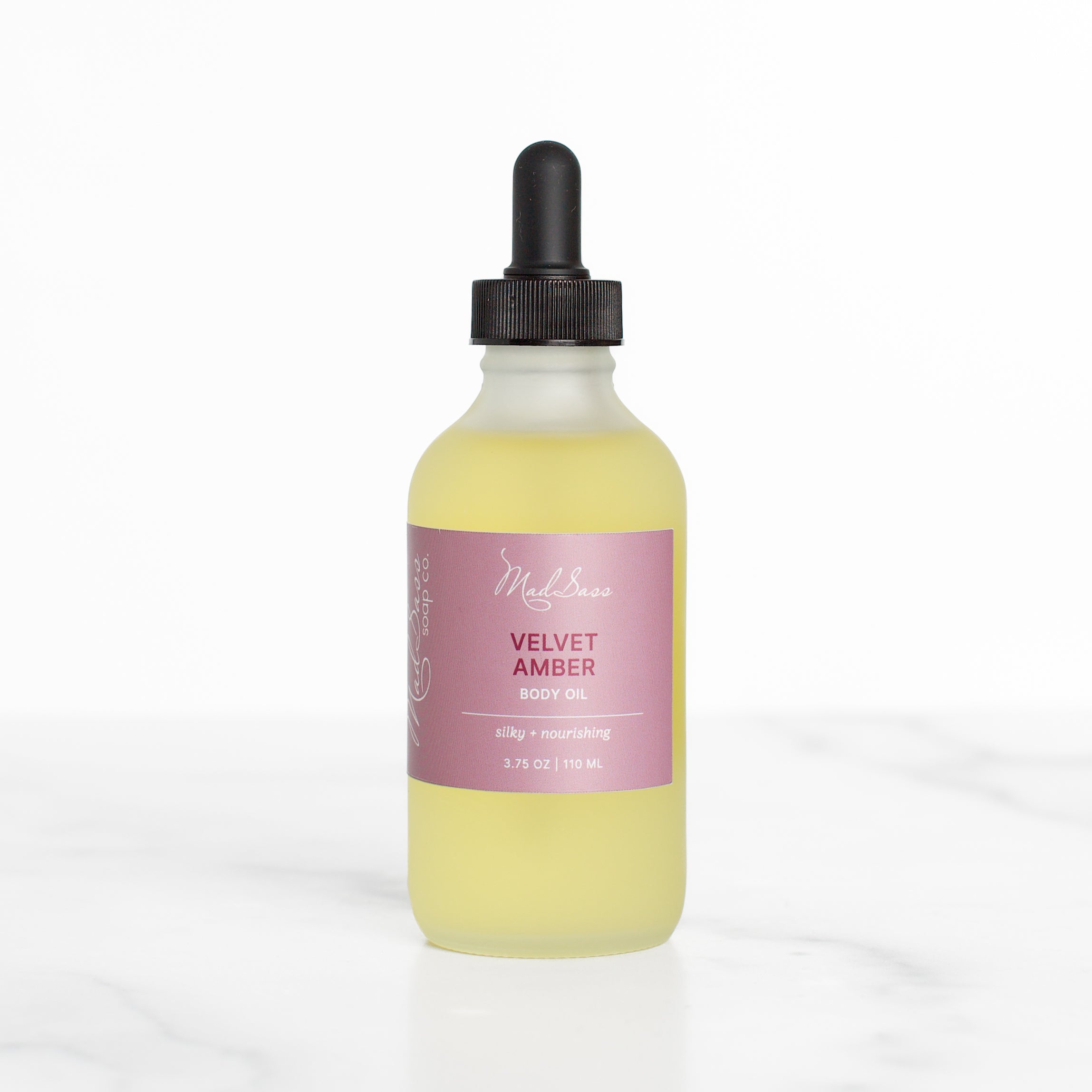 Mad Sass Soap Co Velvet Amber - Body Oil in a sleek bottle, showcasing a luxurious skin nourishing body oil designed for soft, radiant skin.